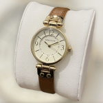 Reloj Anne Klein 109442CHHY para mujer, dorado con esfera champán y correa de cuero café